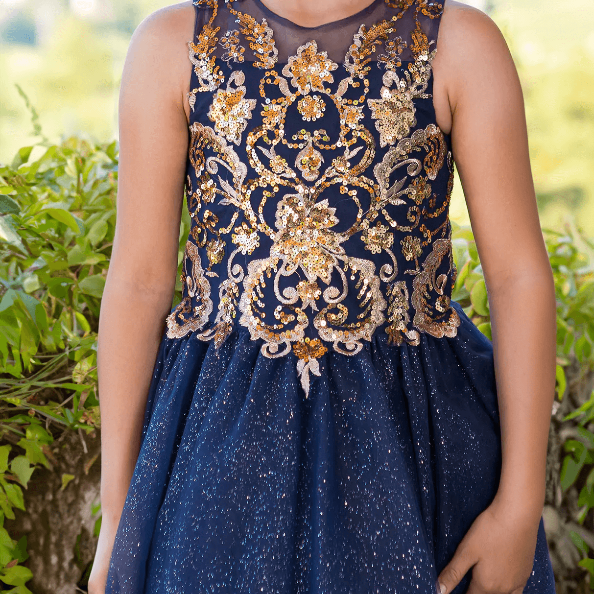 girl wearing a navy and gold sequin dress