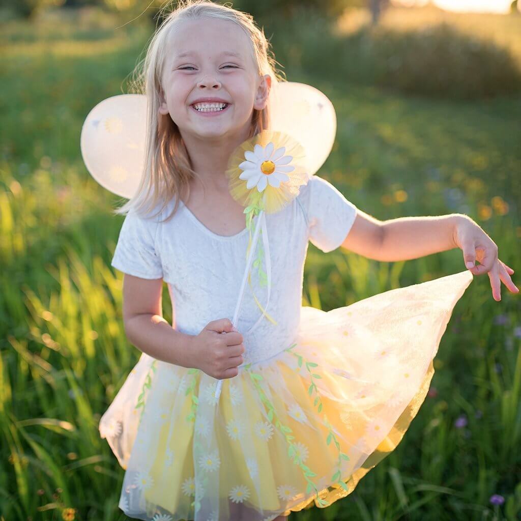 girl wearing daisy yellow and white tutu skirt with matching wings and wand