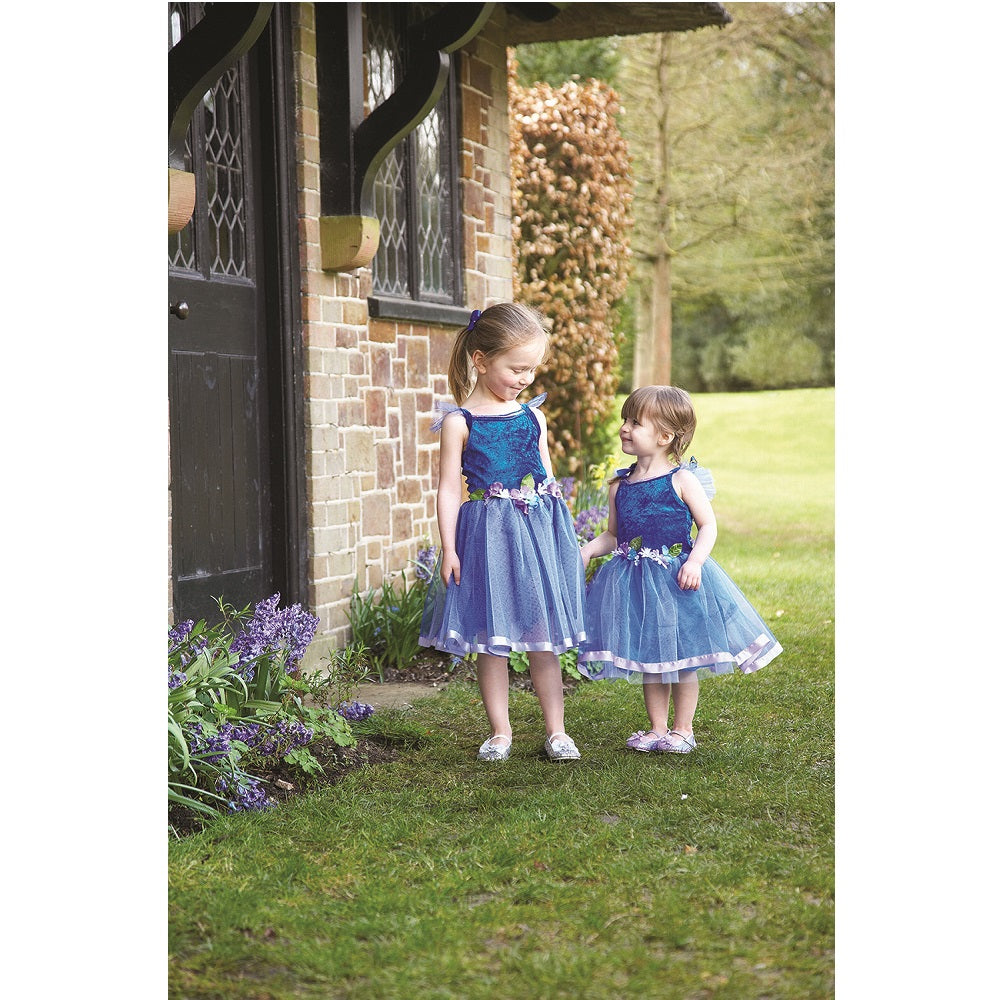 Two girls in a garden wearing royal blue Flower Fairy costumes