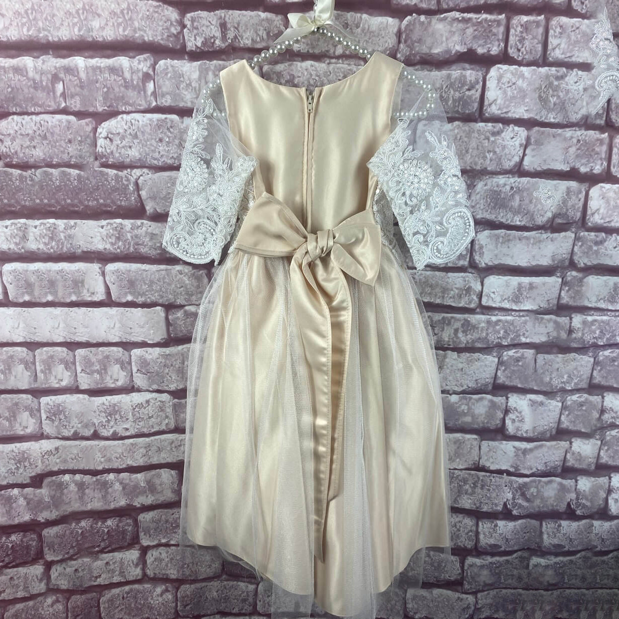 Harlow dress in Champagne colour on a hanger
