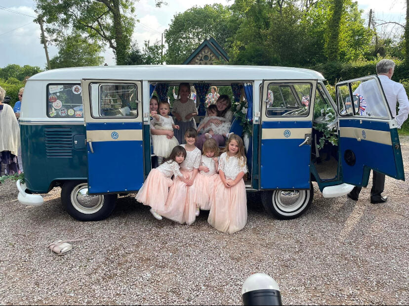 Flower girls and babies in camper van for wedding 