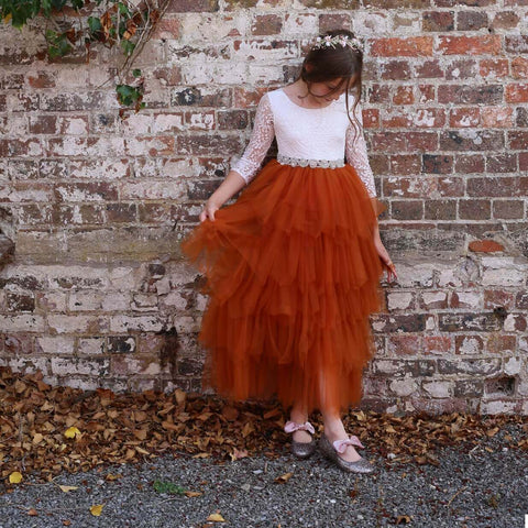 Young girl against wall