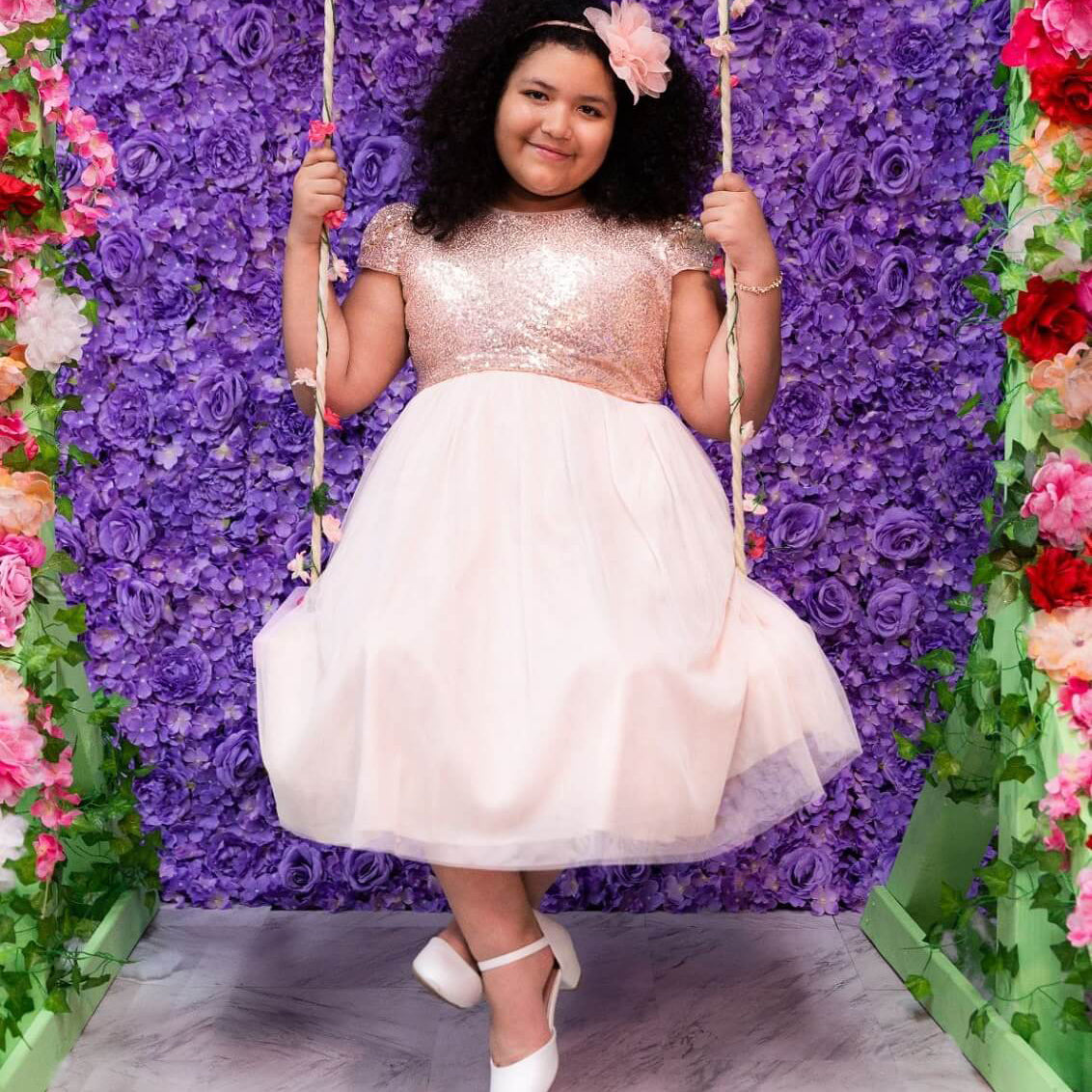 Girl on a swing in a UK Flower Girl party dress
