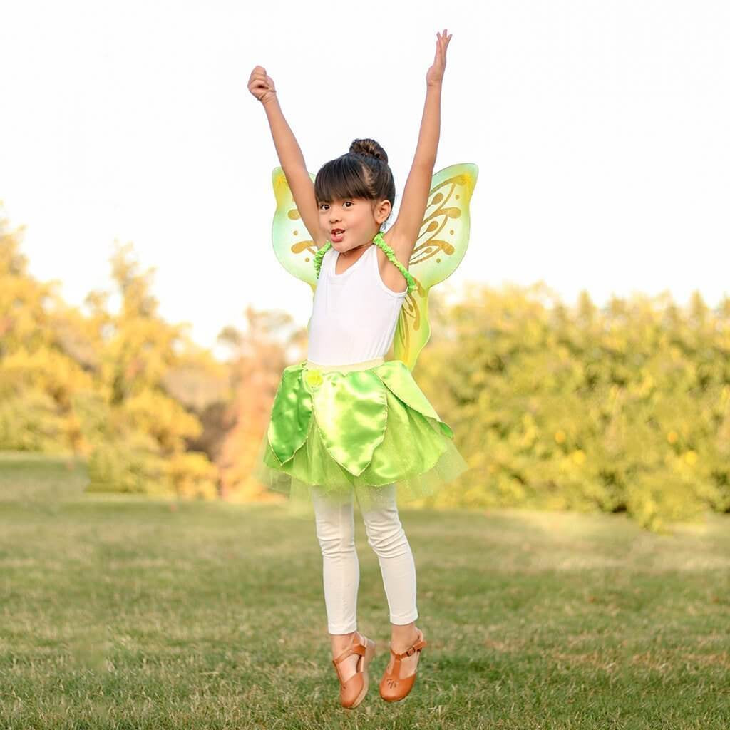 Young girl jumping wearing green and gold glitter fairy wings with green petal tutu skirt