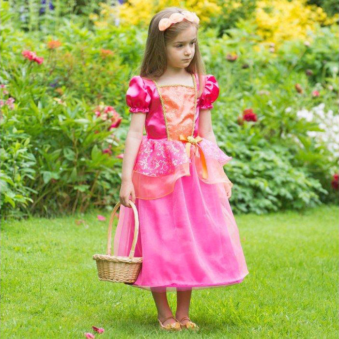 girl in a garden wearing a Vibrant orange and pink Princess costume with matching headband