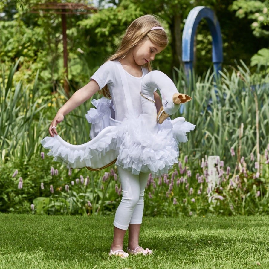 girl wearing swan costume in a garden