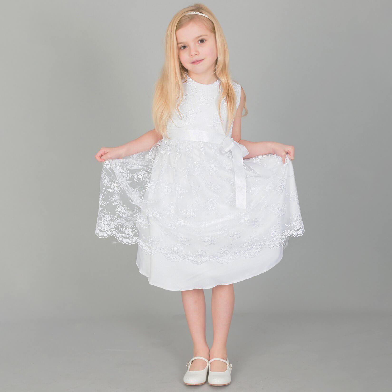 Girl wearing a white flower girl dress