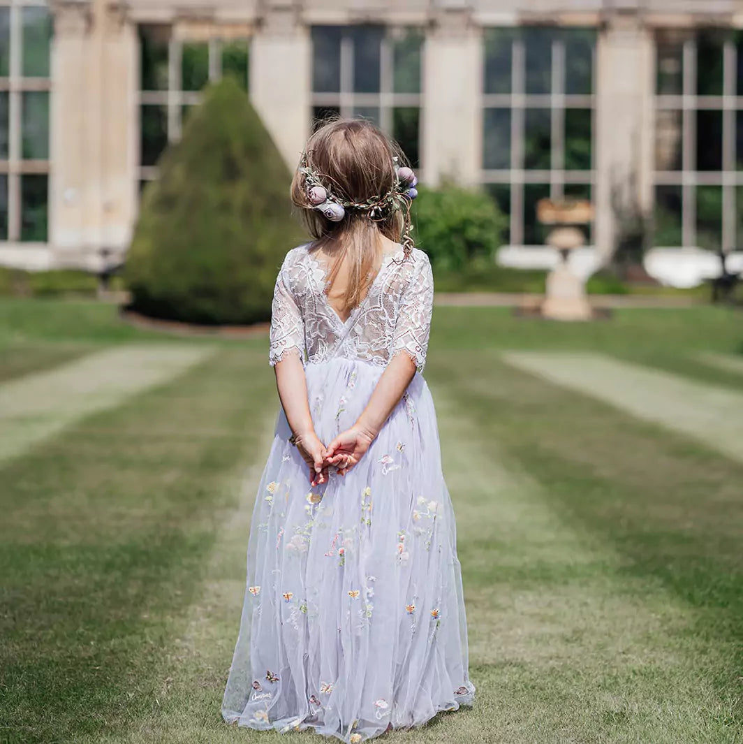 young girl looking at stately home