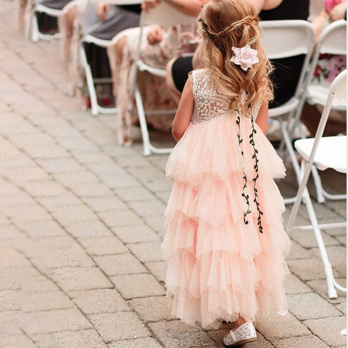 Young girl wearing blush coloured flower girl dress