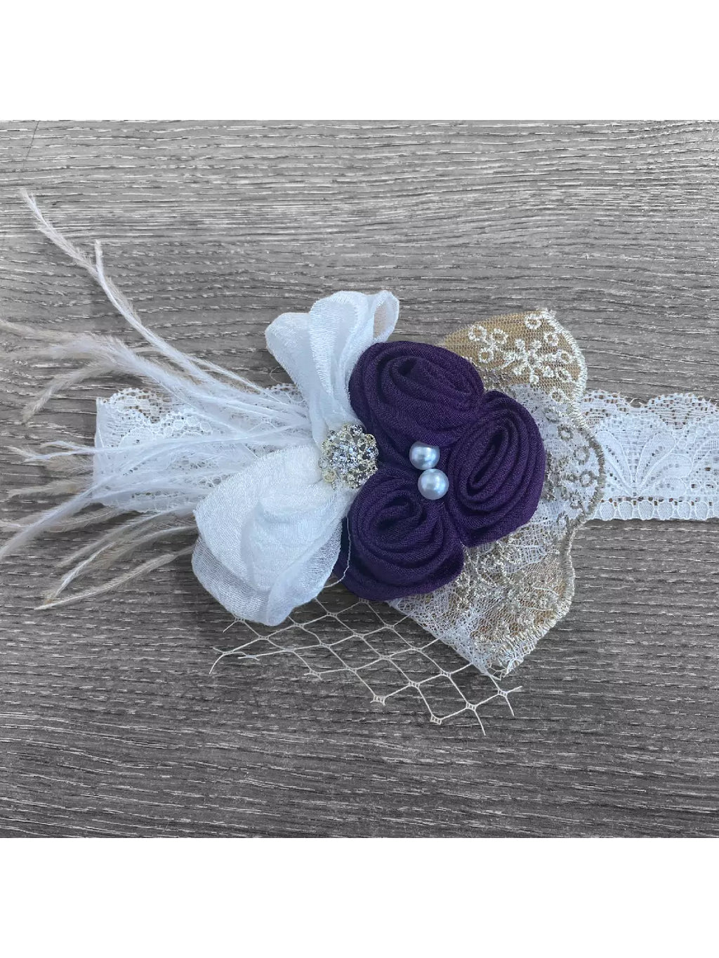 purple head piece with feather and flowers